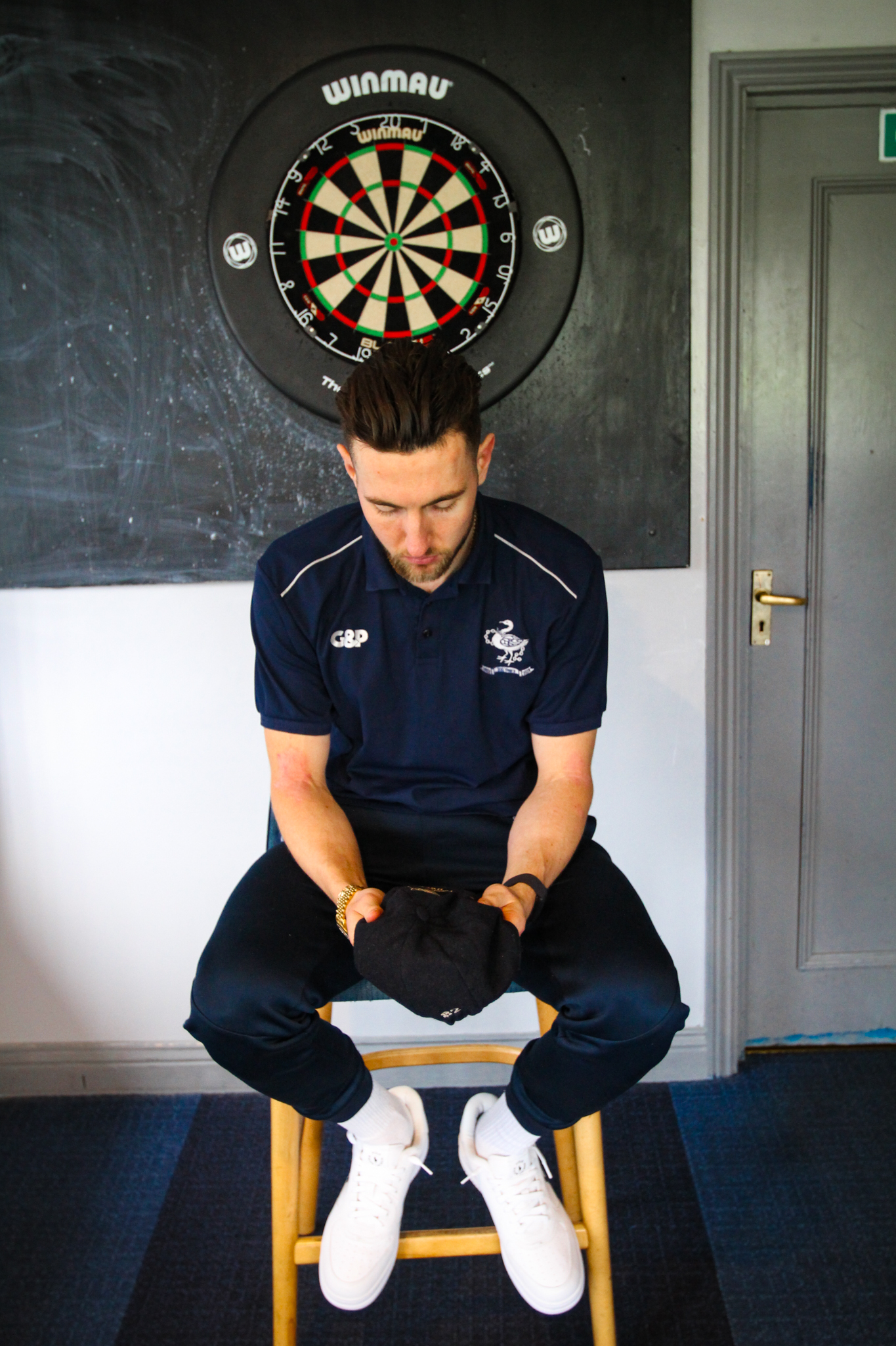 Conner Haddow looking at his baggy cap with pride.